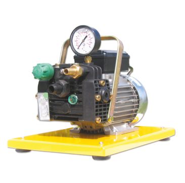 Yellow-based Aspen Pumps HydroPump Flushing Pump with a black diaphragm pump, pressure gauge, green cap, and brass fittings designed for HVAC refrigerant circuit flushing.