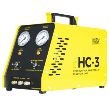 Yellow Javac Caresaver HC-3 Hydrocarbon Refrigerant Recovery Unit with a black control panel, featuring two pressure gauges labeled 'Discharge Pressure' and 'Recovery Pressure,' a 'Hot Gas/Cool Gas' switch, a 'Low Pressure Override' switch, and ports for 