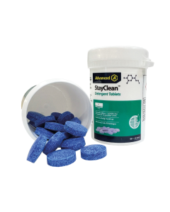 A white plastic bottle labelled "Advanced A StayClean Detergent Tablets" with a blue cap contains small, round blue tablets for air conditioning drain maintenance. Several blue tablets spill out onto a white surface, and green accents on the label highlig