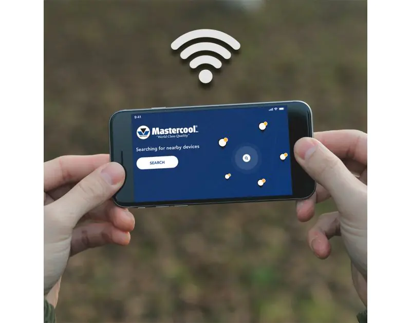 A smartphone displaying the Mastercool Connect app with a blue interface, showing 'Searching for nearby devices' and a 'Search' button. The screen features the Mastercool logo and a Bluetooth icon above, with two hands holding the phone against a blurred 