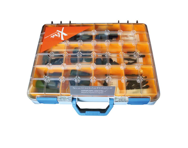 Clear plastic organiser box with orange dividers containing assorted air conditioning condensate management accessories from Aspen Xtra, labelled with the Xtra brand and Aspen Pumps website on the front.