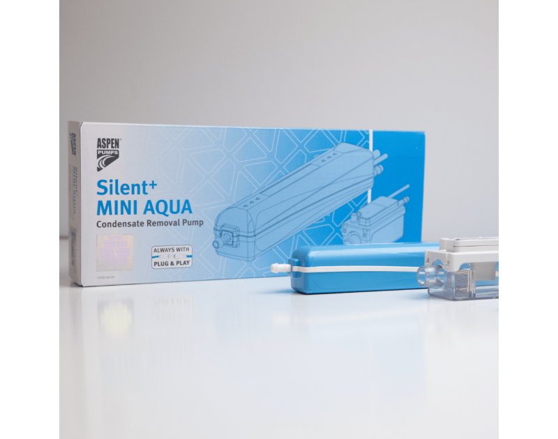 The box and components of the Silent+ Mini Aqua Condensate Removal Pump by Aspen Pumps feature a blue pump, a clear reservoir with a lid, and packaging with a plug-and-play label. The box and components of the Silent+ Mini Aqua Condensate Removal Pump by Aspen Pumps feature a blue pump, a clear reservoir with a lid, and packaging with a plug-and-play label.