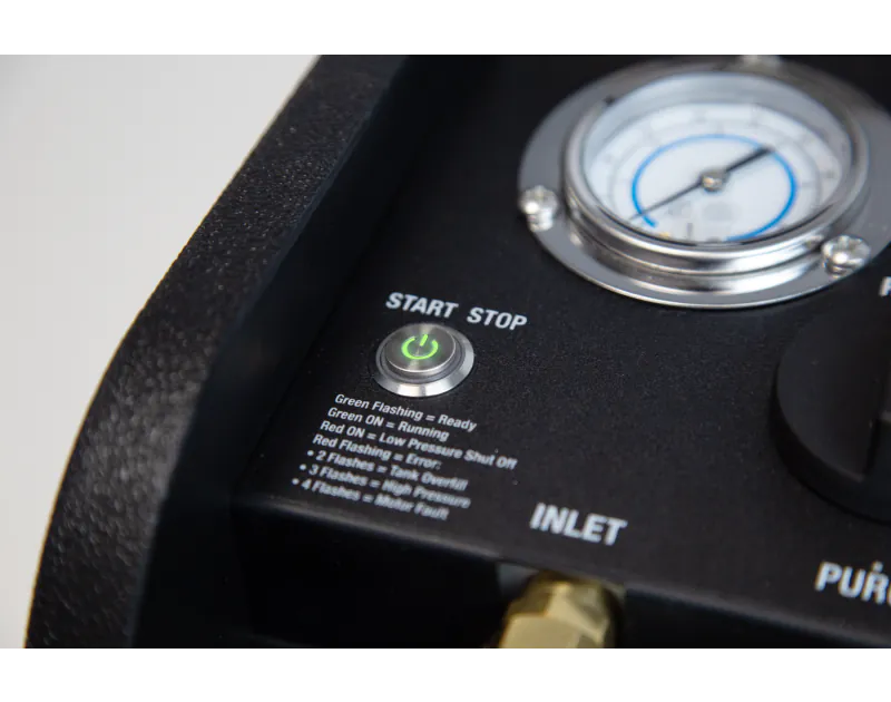Close-up of the JAVAC Velo-X Twin Cylinder Recovery Unit Pro start/stop button with a green flashing LED, labeled 'START STOP,' alongside a pressure gauge and status indicators for 'Green Flashing = ON,' 'Red ON = Low Pressure,' and error codes for tank o