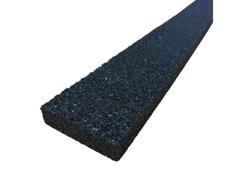 A close-up image of a black rubber anti-vibration strip with a textured surface, measuring 1m x 75mm x 15mm. The strip is shown against a black background, highlighting its thickness and porous structure, which is ideal for reducing noise and vibrations i