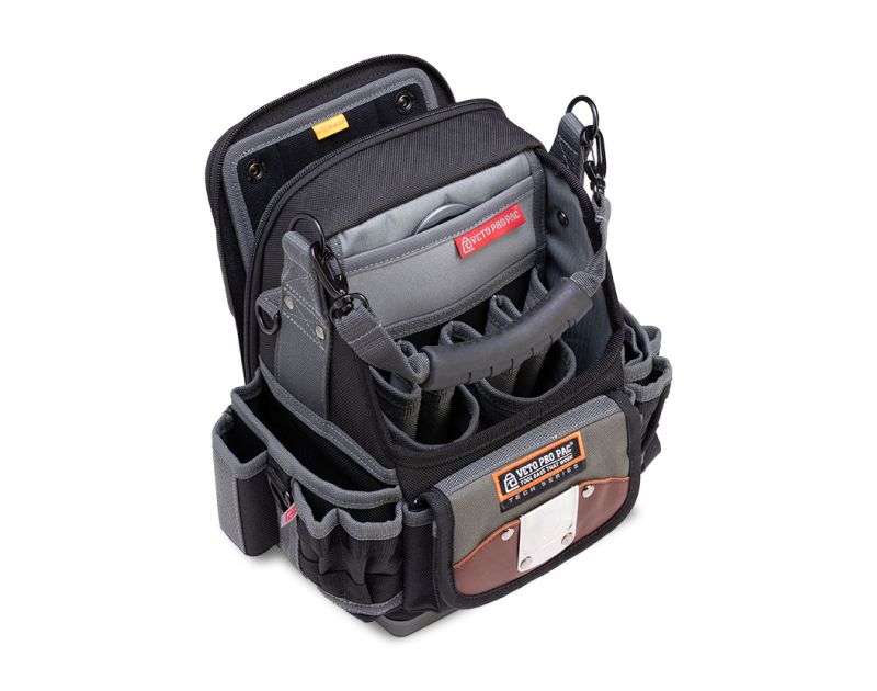 A Veto Pro Pac SB-LD Hybrid Tool and Meter Bag (AX3672) with an open-top design, showcasing multiple exterior pockets, a padded shoulder strap, and a rugged waterproof base. The bag features a grey and black colour scheme with a red Veto Pro Pac logo and A Veto Pro Pac SB-LD Hybrid Tool and Meter Bag (AX3672) with an open-top design, showcasing multiple exterior pockets, a padded shoulder strap, and a rugged waterproof base. The bag features a grey and black colour scheme with a red Veto Pro Pac logo and